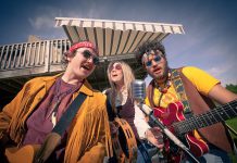 In Beau Dixon's "Bloom: A Rock 'n' Roll Fable", Owen Stahn (left) is Neph Burnstall and Eli Tanner (right) is Griffin Clark, two childhood friends who grow up to form the 1960s Canadian rock 'n' roll band The Spruce Street Ramblers, which rises to fame only after Tess Wilson (played by Kate Suhr, centre) joins the band. Directed by Kim Blackwell, the play runs every Tuesday to Saturday at 4th Line Theatre in Millbrook until July 27, 2019. (Photo: Wayne Eardley / Brookside Studio)