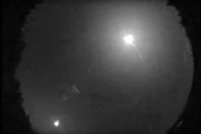 A still from a video of a fireball (upper right) captured by Western University's All-Sky Camera Network at 2:44 a.m. on July 24, 2019. As bright as a full moon (the waning moon is pictured in the lower left), the fireball disintegrated south of Bancroft and is likely to have dropped small meteorites in the area. (Photo: Western University)