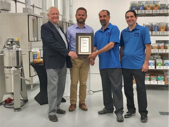 Darren and Ryan Goldin of Etomo Farms in Norwood (right) receive an inaugural Excellence in Agriculture Award from Ontario Minister of Agriculture, Food and Rural Affairs Minister Ernie Hardeman and Northumberland-Peterborough South MPP David Piccini on July 4, 2019, in recognition of the company's innovation in producing food products from crickets. (Photo: Ontario Ministry of Agriculture, Food and Rural Affairs)