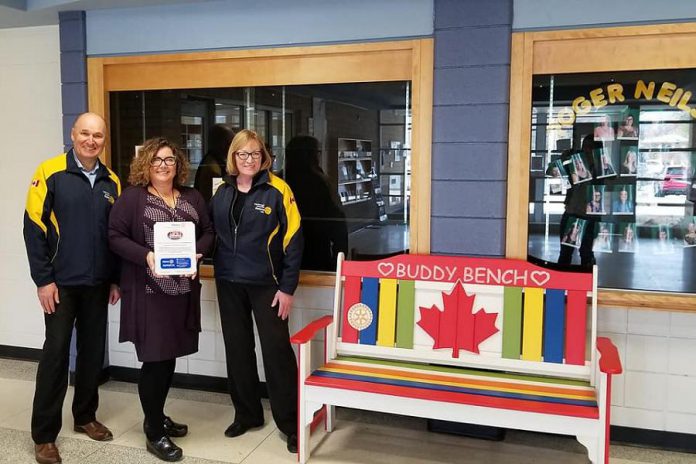 Donna Geary (right) with  Rotary Club of Peterborough Kawartha president Brian Prentice and principal Denise Humphries after the donation of a buddy bench to the school. Donna and her son Nate began the initiative in 2017. (Photo: Rotary Club of Peterborough Kawartha)