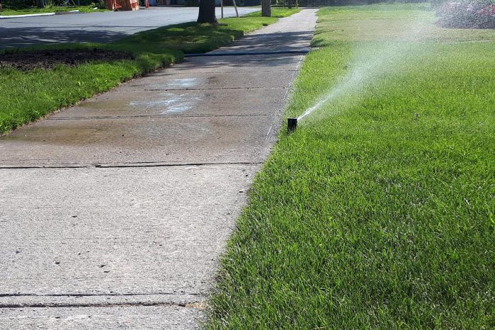 This summer, skip the sprinkler and rely on the rain. While sprinklers mostly water lawns, they also water unwanted places like sidewalks, driveways, and pedestrians. It is increasingly important to use less water outside and to recognize wasteful usage, especially in the summer when our water supply is most stressed. (Photo: Heather Ray)