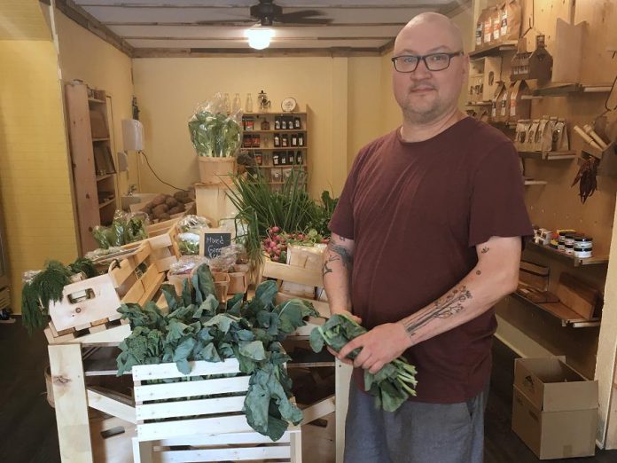 Anthony Lennan offers a variety of fresh produce and local groceries at The Food Shop in downtown Peterborough. (Photo: Eva Fisher / kawarthaNOW.com)