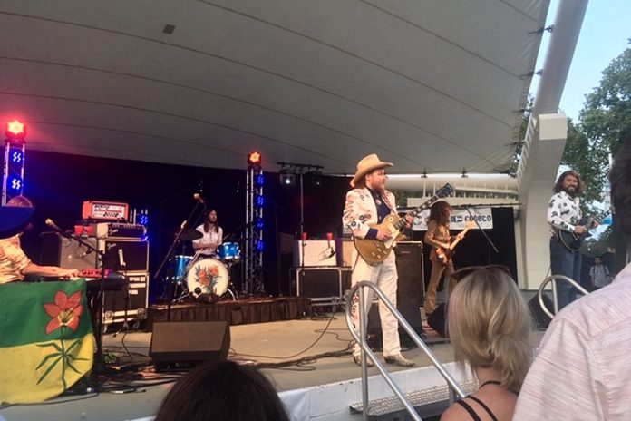 Baileboro native Jimmy Bowskill takes centre stage at The Sheepdogs concert at Peterborough Musicfest in Del Crary Park on July 24, 2019. Eleven people attending the free concert were charged under the City of Peterborough's no-smoking for smoking, vaping, and using cannabis. (Photo: Eva Fisher / kawarthaNOW.com)