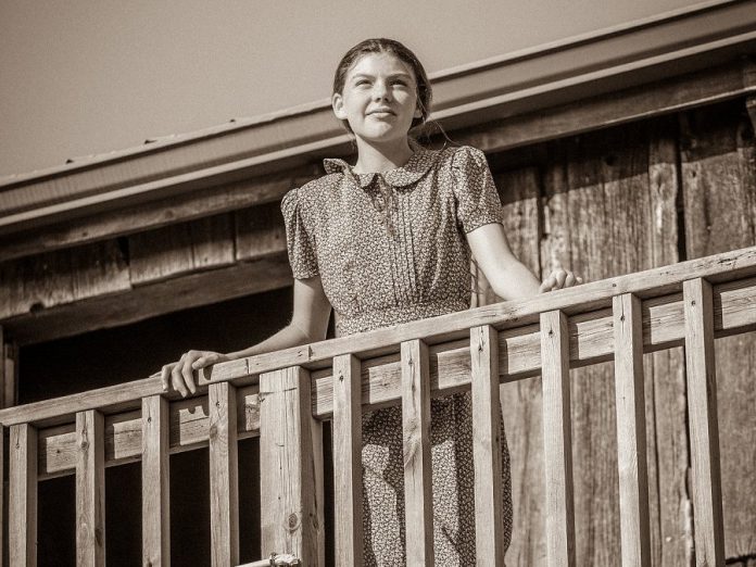 Asha Hall-Smith is the play's narrator and the audience's guide through the drama  in Robert Winslow and Ian McLachlan's "Carmel" at 4th Line Theatre. (Photo: Wayne Eardley / Brookside Studio)