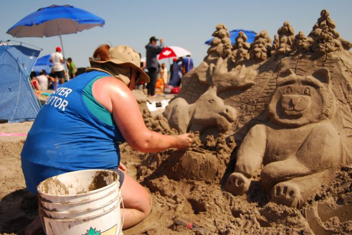 Master sculptor Tanya Kastl of Waterloo works on her design during the Cobourg Sandcastle Festival on August 3, 2019 at Victoria Beach in the Town of Cobourg. (Photo: April Potter / kawarthaNOW.com)