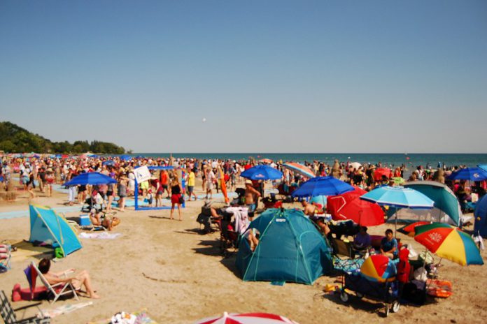 Crowds of people filled Cobourg's Victoria Beach on the shores of Lake Ontario for the town's 14th annual sandcastle festival  on August 3, 2019. (Photo: April Potter / kawarthaNOW.com)