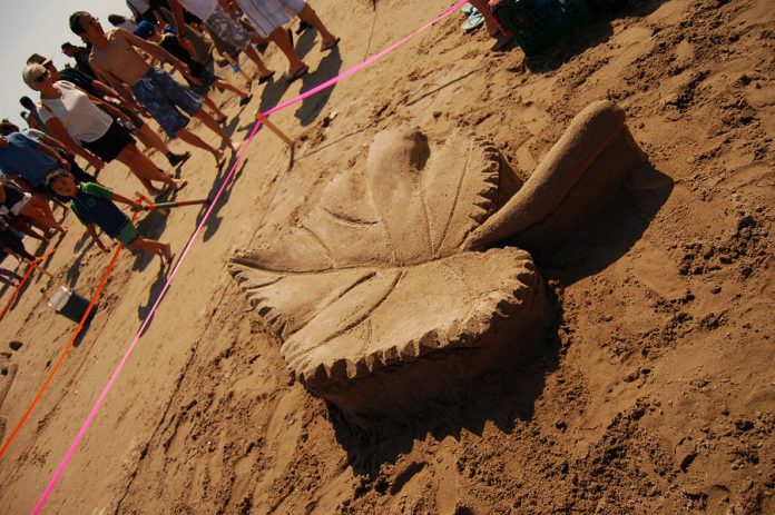 Saara Nurmi, who live in Finland but summers in Canada, created this sculpture of a basswood leaf  at the Cobourg Sandcastle Festival on August 3, 2019 at Victoria Beach in the Town of Cobourg. (Photo: April Potter / kawarthaNOW.com)
