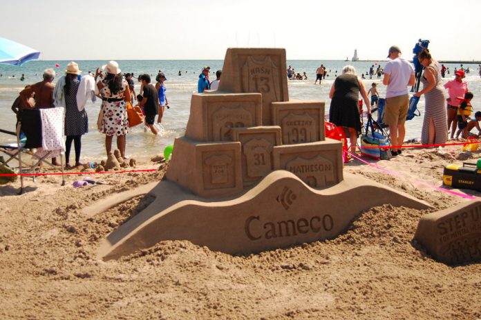 At the Cobourg Sandcastle Festival on August 3, 2019 at Victoria Beach in the Town of Cobourg, master sculptor Dale Andrews created the sports-themed design for corporate sponsor Cameco, showcasing the jerseys of prominent athletes on Canadian sports teams and celebrating our country's love of sport.   (Photo: April Potter / kawarthaNOW.com)