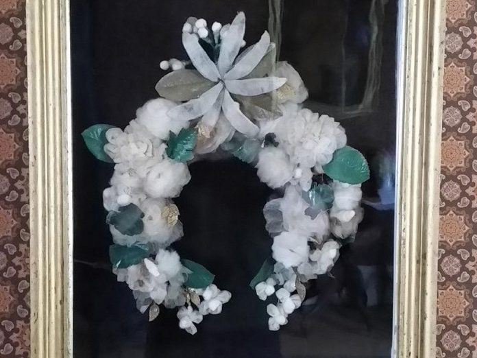 Decorative homemade wall wreaths, like this wool and felt one in display in Milburn House at Lang Pioneer Village Museum in Keene, were a décor item unique to rural Ontario. The wreaths were also made of other materials including as feathers, seeds, shells, and even the hair of loved ones. (Photo courtesy of Lang Pioneer Village Museu
