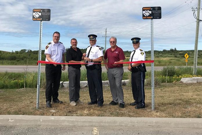 Two Project Safe Trade parking spots were launched at the Kawartha Lakes OPP Detachment in Lindsay on August 15, 2019. Pictured are Municipal Law Enforcement Manager Aaron Sloan, Mayor Andy Letham, Inspector Tim Tatchell, Councillor Ron Ashmore, and Staff Sergeant Robert Flindal. (Photo courtesy of the municipality of Kawartha Lakes)
