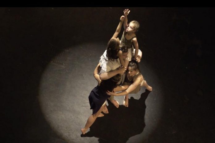 The film's title "Surfacing" refers to the eventual journey towards healing of writer Frank Flynn and his two daughters (represented here as their younger and older selves) following the loss of their mother to suicide. Pictured are dancers Lilly Manning, Laine Andrews, Oliver Moriarty, Madison Sheward, and Kate Bemrose. (Screenshot)