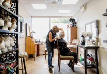 From the Neck Up owner Frances Fourcaudot working on a client at her boutique in the Westmount Pharmacy building in Peterborough. Frances is a hair loss and trichology (hair and scalp health) specialist who offers a selection of full and partial custom-styled human hair wigs, synthetic wigs, and hair toppers, as well as wig repairs, for women, men, and children who experience temporary or permanent hair loss. (Photo: Heather Doughty)