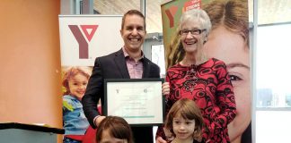 YMCA of Central East Ontario board chair John Mastorakos presents Peterborough educator and activitist Rosmary Ganley with the 2018 YMCA Peace Medal on November 23, 2018 as Ganley's grandaughters Ava and Emma look on. Nominations for the 2019 Peace Medal are now open. (Photo: YMCA of Central East Ontario / Facebook)