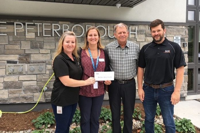 Hospice Peterborough executive director Hajni Hos (second from left) accepts a $1,250 cheque from Ella Mihailescu, Tom Rowden, and James Brown. The funds were raised at SGS Lakefield's Hydrometallurgy Group BBQ. (Photo courtesy of Hospice Peterborough)