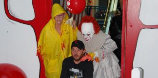 Adam Pearson, owner of Queenies Bake Shop, at a special screening of "IT Chapter Two" at Cobourg's Rainbow Cinemas in Northumberland Mall on September 5, 2019, along with costumed fans Laurie Statt and Melindah Knott. Pearson, with the help of local artists and volunteers, created a large-scale art project for the screening which also raised funds for the Northumberland Fare Share Food Bank. Pearson, whose Port Hope business benefited from the production of the film, appears as an extra who get shoved out of the way by actor James McAvoy during the film's funhouse scene. (Photo: April Potter / kawarthaNOW.com)