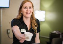 Cindy White, Business Development Assistant at Peterborough & the Kawarthas Economic Development, hands out a cup of ice cream at the Peterborough & the Kawarthas Visitor Centre at the annual 'Get The Scoop' event on Friday, July 5, 2019. (Photo: Alyssa Cymbalista)