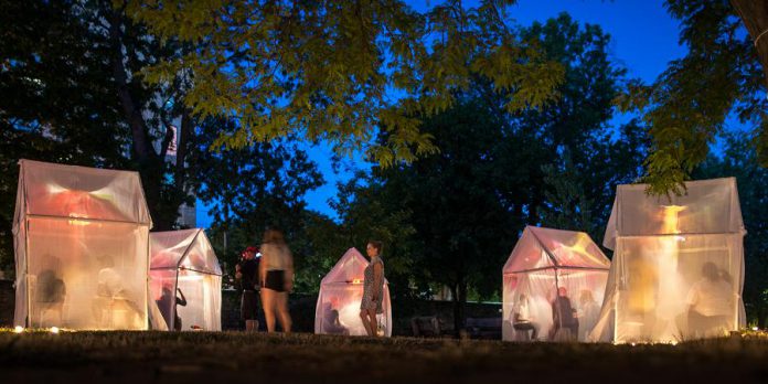 "Trophy" is a free event where audience members can move between lighted tents to listen to local stories of life-changing moments of transformation. (Photo: Dahlia Katz)