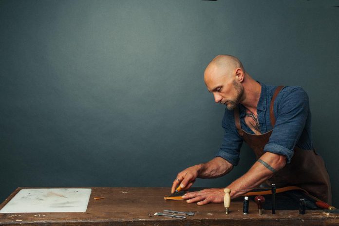 Leather artist Jesse Bateson, owner of Solid Leather, working on one of his custom-made belts in his downtown Peterborough workshop. Unlike most off-the-shelf belts, Bateson's are 100 per cent solid leather and he also guarantees them for life. Solid Leather offers both a casual and formal line of belts in rich and classic colours, with the holes in Bateson's belts spaced closer together than other belts to provide the best possible fit. (Photo: Max Power Photography)