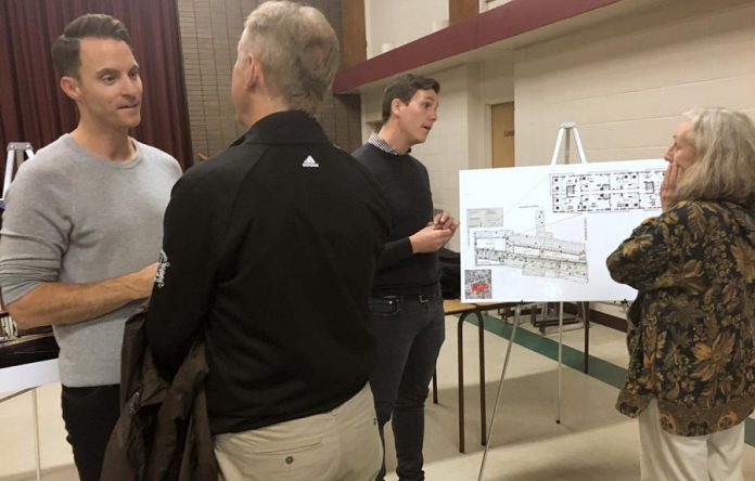 Ashburnham Realty owner Paul Bennett (left) and architect Michael Gallant of Lett Architects (second from right) engaged a number of residents Thursday night (October 24) at an open house and information session concerning plans for the mixed-use residential-commercial development of several properties in East City. (Photo: Paul Rellinger / kawarthaNOW.com)