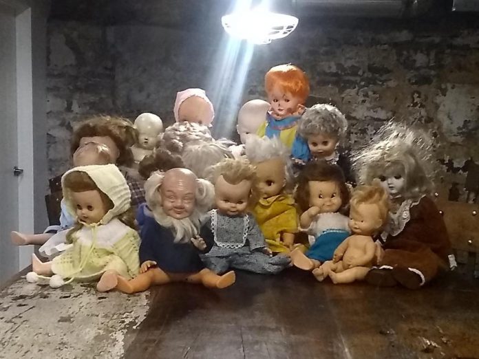 Kathryn Bahun and Ben Hatcher have been collecting discarded dolls for almost two years, and have amassed a collection of 50 of them. Even illuminated by a bright light, the dolls still have a strong creep factor. (Photo: Sam Tweedle / kawarthaNOW.com)