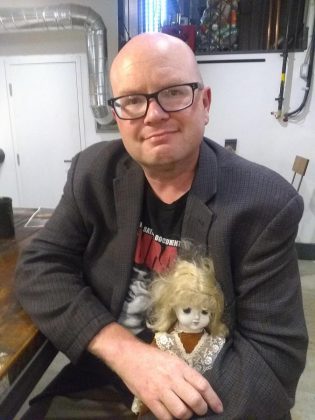 Sam Tweedle spending some quality time with one of Kathryn Bahun's dolls. "I've had it haunt my dreams," Sam writes. (Photo courtesy of Sam Tweedle)