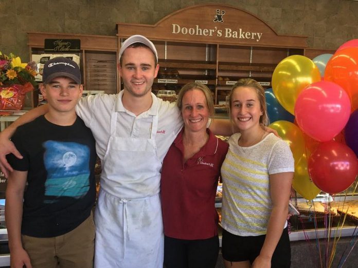 Dooher's Bakery owner Cory Dooher (second from right) with her children Spencer, Jeremy, and Hannah, who also work at the bakery. (Photo courtesy of Dooher's Bakery)