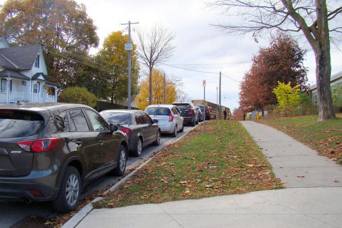 A common sight at Peterborough-area schools during drop-off and pick-up times: a long line of idling cars on Robinson Street beside Immaculate Conception Catholic Elementary School in Peterborough's East City. Empty sidewalks are an indication that there is potential to shift towards active methods of school travel instead of relying on cars. Relying on cars for school travel reduces air quality, physical activity, and opportunities for independence while also increasing social isolation. To help address these issues, Immaculate Conception is one of five local schools participating in the new School Travel Planning program delivered by GreenUP and Active and Safe Routes to School Peterborough. (Photo courtesy of GreenUP)