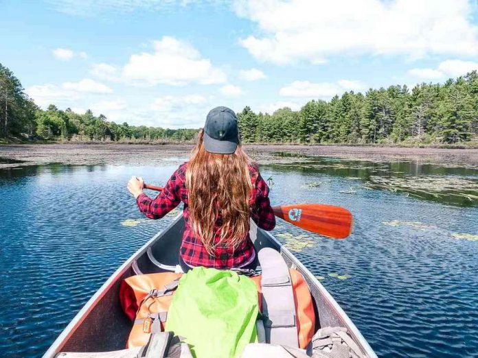 A member of the Toronto Bloggers Collective canoeing on Copper Lake in Kawartha Highlands Provincial Park. (Photo: walkaboot.ca)