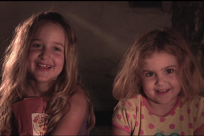 Zoe Hayes and Emma Hayes, daughters of filmmaker Michael Hayes, play two sisters in the short film "The Basement Monster". The funny and moving family film explores both the power of sisterhood and being kind and accepting of others who are different. (Screenshot courtesy of Michael Hayes and Brendan Fell)