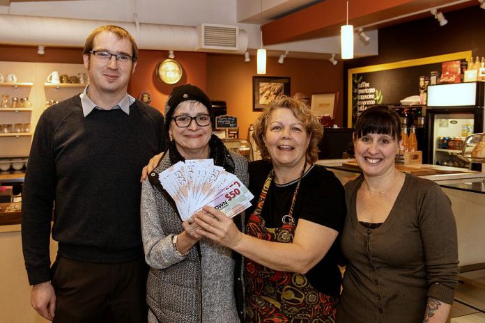 Shoppers who complete their Holiday Shopping Passports are entered into draws for "downtown money" (gift certificates that can be redeemed at participating businesses and organizations). Pictured is Avis Moores of Omemee (second from left), who won the grand prize of $1,500 in downtown money during the 2018 Holiday Shopping Passport program. Also pictured are Joel Weibe of the DBIA and  Anita Morris and Barb Collins at Simply Delicious at 197 Charlotte Street in downtown Peterborough on January 9, 2019. (Photo courtesy of Peterborough DBIA)