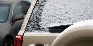 Car window covered with light snow