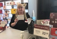 An employee at Shoppers Drug Mart displays a fraud prevention card, supplied by the Kawartha Lakes Police Service, that retailers can share with customers who are at risk of falling victim to the gift card scam. (Supplied photo)