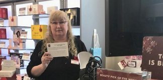 An employee at Shoppers Drug Mart displays a fraud prevention card, supplied by the Kawartha Lakes Police Service, that retailers can share with customers who are at risk of falling victim to the gift card scam. (Supplied photo)