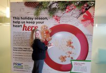 Meghan Moloney, Charitable Giving Advisor with the Peterborough Regional Health Centre (PRHC) Foundation, adds a Grateful Hearts cookie tribute featuring a message of thanks to the PRHC Foundation's "big plate" holiday display in the hospital's main lobby. By making a donation to the PRHC Foundation this holiday season, you can not only share your message or holiday greetings with doctors, nurses, and staff of our regional hospital, but your donation will help to fund needed new equipment and technology at the hospital's Cardiac Catheterization Lab, which provides life-saving care to thousands of people every year. (Photo courtesy of PRHC Foundation)