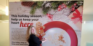 Meghan Moloney, Charitable Giving Advisor with the Peterborough Regional Health Centre (PRHC) Foundation, adds a Grateful Hearts cookie tribute featuring a message of thanks to the PRHC Foundation's "big plate" holiday display in the hospital's main lobby. By making a donation to the PRHC Foundation this holiday season, you can not only share your message or holiday greetings with doctors, nurses, and staff of our regional hospital, but your donation will help to fund needed new equipment and technology at the hospital's Cardiac Catheterization Lab, which provides life-saving care to thousands of people every year. (Photo courtesy of PRHC Foundation)