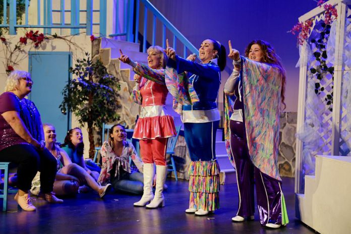 Donna and the Dynamos (Christie Freeman as Tanya, Natalie Dorsett as Donna, and Lyndele Gauci as Rosie) in their '70s disco garb while singing "Super Trouper"  in the St. James Players production of the hit musical "Mamma Mia!". (Photo: Wendy Morgan)