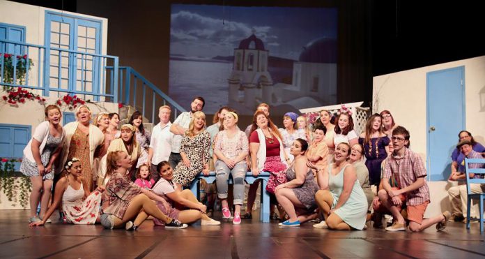 Natalie Dorsett as Donna, Christie Freeman as Tanya, and Lyndele Gauci as Rosie (sitting on the table) with the ensemble cast of the St. James Players production of the hit musical "Mamma Mia!". (Photo: Wendy Morgan)