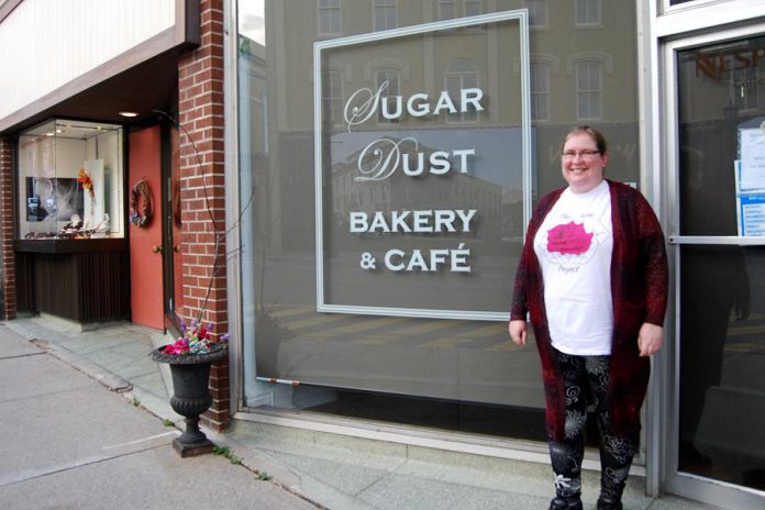Rose Wilton, founder of The Rose Project, in front of Sugar Dust Bakery on Walton Street in Port Hope where you can donate toiletries or warm gloves, mittens, and hats for people in need. You can also bring donations to The Rose Project's inaugural Holiday Craft Show at the Town Park Recreation Centre on November 23, 2019, which features vendors offering a selection of hand-crafted items for your holiday shopping. (Photo: April Potter / kawarthaNOW.com)