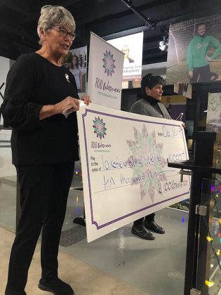 Lakefield Animal Welfare Society manager Janet Evans and past chair Mary Power accept the donation of more than $10,000 from collective philanthropy group 100 Women Peterborough in the lobby of the VentureNorth building in downtown Peterborough on December 17, 2019.  (Photo courtesy of 100 Women Peterborough)