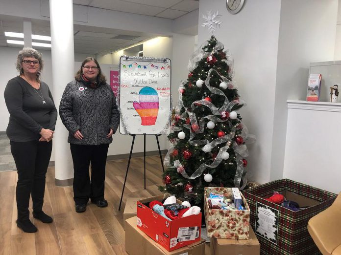 Scotiabank Port Hope manager Heather Hennings with The Rose Project founder Rose Wilson, who visited the branch on December 27, 2019 to pick up five boxes filled with 59 pairs of mittens, hats, scarves, toiletries, small gift cards, and granola bars. Branch employees, clients, and customers donated the items to support The Rose Project, which collects donations for the less fortunate in Northumberland County. (Photo: Cassidy Dawson)