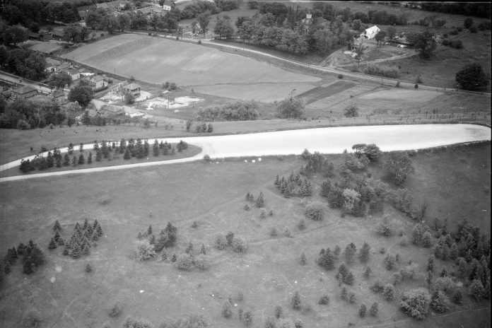 Armour Hill in Peterborough with the developing East City-Curtis Creek neighbourhood in the background, circa 1950. (Photo courtesy of Peterborough Museum and Archives, Parks Studio fonds, P-12-665-1)