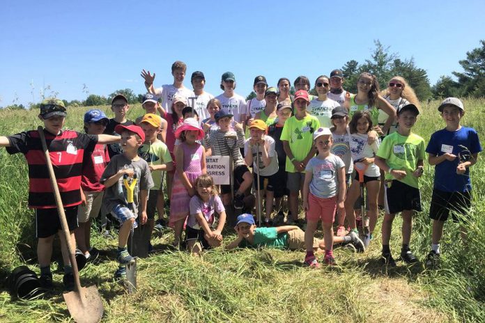 Youth campers from TRACKS participating in in a tall grass restoration initiative at John Earle Chase Memorial Park in Trent Hills, one of the properties protected by Kawartha Land Trust. (Photo courtesy of Kawartha Land Trust)