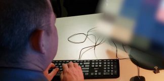 A police investigator at work during Project Peacehaven, a joint investigation by the Ontario Provincial Police and the Peterborough Police Service into online child sexual exploitation that has resulted in charges against eight people, including an Omemee resident and a Selwyn Township resident. (Photo: OPP)