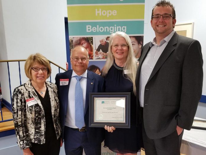 Kevan and Roberta Herod (centre) and members of the Herod Financial Services team with a distinguished service award from the Canadian Mental Health Association, Haliburton, Kawartha, Pine Ridge.  (Supplied photo)