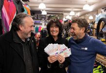 Karen Procyk of Peterborough collects her grand prize of $1,500 in "downtown money" at Wild Rock Outfitters on 169 Charlotte Street after her Holiday Shopping Passport was drawn at the culmination of the annual initiative by the Peterborough Downtown Business Improvement Area (DBIA) to encourage people to choose local. Also pictured is DBIA executive director Terry Guiel (left) and Wild Rock Outfitters co-owner Kieran Andrews. (Photo courtesy of Peterborough DBIA)