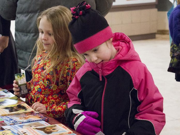 Young readers check out the books on display at last year's annual Family Literacy Day in Peterborough Square. This year's Saturday morning event, with the theme "Once Upon A Turtle", takes place on January 25, 2020 in the lower level of in Peterborough Square. It features children's author Andrew Larsen, Plugging Into Nature music and puppet show, a live turtle exhibit by Ontario Turtle Conservation Centre, Celebrity Readers' Theatre, and face painting. Admission is free and every child leaves with a free book. (Photo courtesy of Peter Rellinger)