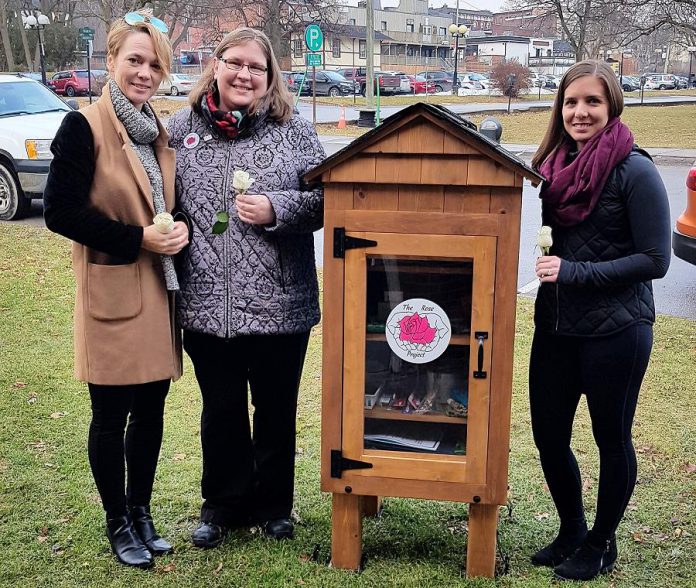 Artist Lee Higginson (left), The Rose Project founder Rose Wilton (middle), and designer and carpenter Courtney Sutton (right) with The Rose Project's personal care community cupboard, located behind Town Hall in Port Hope. Wilton will keep the cupboard stocked with personal care items needed by the less fortunate, including as toiletries as well as seasonal items such as hats and gloves. (Photo courtesy of The Rose Project)