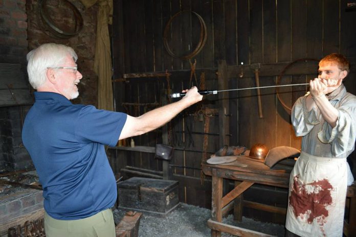 Hugh Foley's trips to Ireland have given him ample material for his stores at Foley's Irish Pub. Here he receives instructions on broad sword fighting. (Photo courtesy of Theresa Foley)