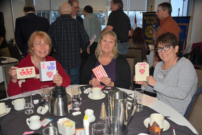 Liz Woosey, Brenda Booth, and Peggy Shaughnessey displaying a few of the customized Valentine's Day cards that Kawartha Rotarians recently created for Hospice Peterborough clients. (Photo courtesy of Rotary Club of Peterborough Kawartha)