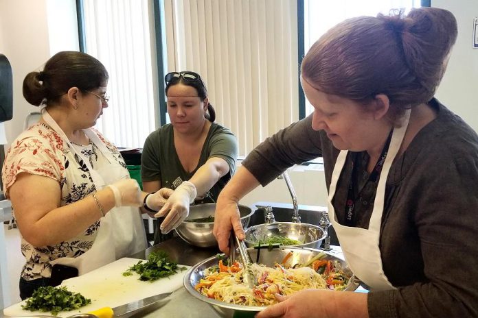 Chef Elaine McCarthy (right) coaches participants at the the Council for Persons with Disabilities' Active Together cooking class. The cooking classes, which are open to anyone over the age of 18 who self-identifies as living with a disability, run every Friday morning during the spring at Peterborough Public Health. (Photo: Council for Persons with Disabilities)